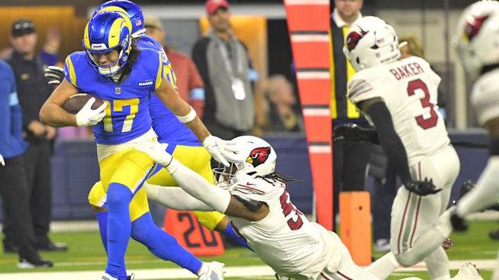 Dec 28, 2024; Inglewood, California, USA;  Los Angeles Rams wide receiver Puka Nacua (17) gains a first down before he is stopped by Arizona Cardinals defensive tackle Dante Stills (55) in the second half at SoFi Stadium. Mandatory Credit: Jayne Kamin-Oncea-Imagn Images