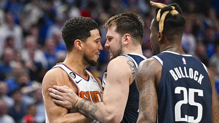 Phoenix Suns guard Devin Booker (1) and Dallas Mavericks guard Luka Doncic.