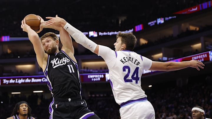 Oct 24, 2025; Sacramento, California, USA; Sacramento Kings center Domantas Sabonis (11) controls a rebound against Utah Jazz center Walker Kessler (24) during the second quarter at Golden 1 Center. Mandatory Credit: Kelley L Cox-Imagn Images