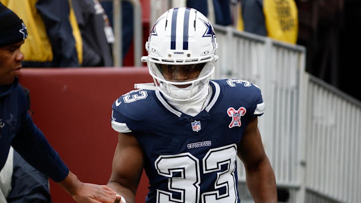 Dallas Cowboys running back Javonte Williams runs onto the field for warmups before a game against the Washington Commanders 