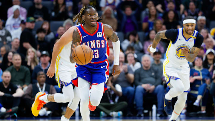 Feb 21, 2025; Sacramento, California, USA; Sacramento Kings guard Keon Ellis (23) steals the ball from Golden State Warriors guard Stephen Curry (30) during the first quarter at Golden 1 Center. Mandatory Credit: Sergio Estrada-Imagn Images