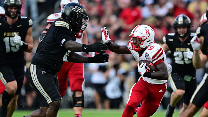 Sep 28, 2024; West Lafayette, Indiana, USA; Nebraska Cornhuskers running back Emmett Johnson (21) runs into Purdue Boilermakers defensive lineman Damarjhe Lewis (34) during the second half at Ross-Ade Stadium.