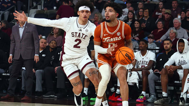 Mar 3, 2025; Memphis, Tennessee, USA; Texas Longhorns guard Jordan Pope (0) handles the ball as Mississippi State Bulldogs guard Riley Kugel (2) defends during the first half at FedExForum. Mandatory Credit: Petre Thomas-Imagn Images