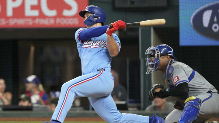 Jun 23, 2024; Arlington, Texas, USA; Texas Rangers left fielder Wyatt Langford (36) follows through on a RBI double against the Kansas City Royals during the fourth inning at Globe Life Field. Mandatory Credit: Jim Cowsert-USA TODAY Sports