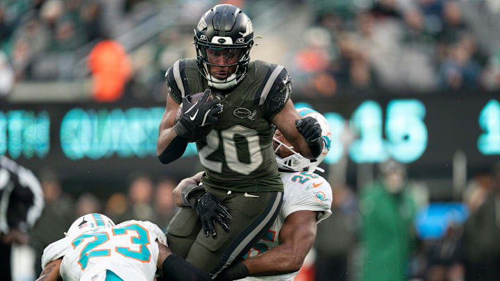 New York Jets running back Breece Hall (20) runs the ball before being tackled by Miami Dolphins linebacker Tyrel Dodson (25) during a week 14 football game between the New York Jets and Miami Dolphins at MetLife Stadium on Sunday, Dec. 7, 2025.