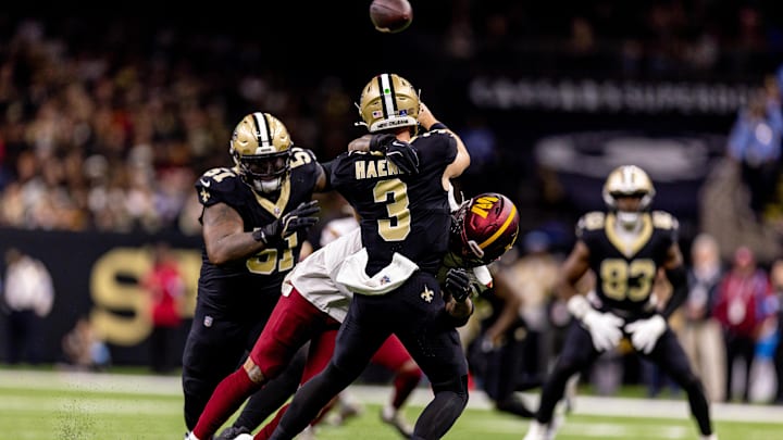 New Orleans Saints quarterback Jake Haener (3) is hit by Washington linebacker Frankie Luvu (4) as he passes