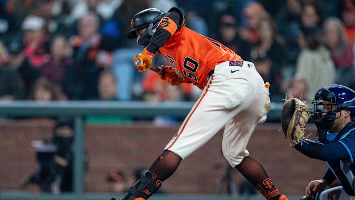 Aug 15, 2025; San Francisco, California, USA; San Francisco Giants second baseman Christian Koss (50) is hit by a pitch against the Tampa Bay Rays during the eighth inning at Oracle Park. Mandatory Credit: Neville E. Guard-Imagn Images