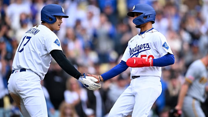Apr 27, 2025; Los Angeles, California, USA; Los Angeles Dodgers designated hitter Shohei Ohtani (17) celebrates with shortstop Mookie Betts (50) after they scored during the first inning against the Pittsburgh Pirates at Dodger Stadium. Mandatory Credit: Jonathan Hui-Imagn Images