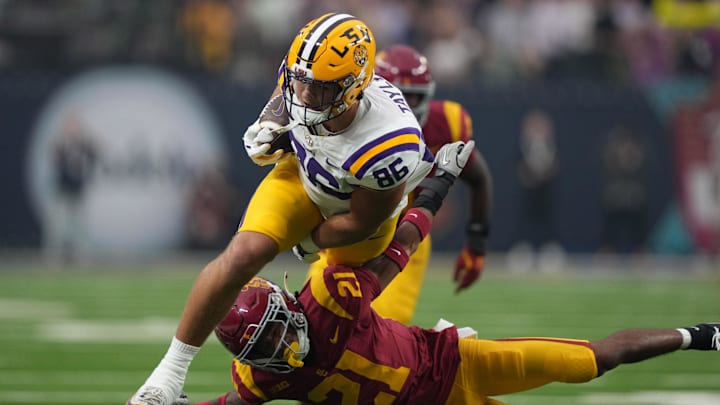 Sep 1, 2024; Paradise, Nevada, USA; LSU Tigers tight end Mason Taylor (86) carries the ball against Southern California Trojans linebacker Desman Stephens II (21) in the first half at Allegiant Stadium. Mandatory Credit: Kirby Lee-Imagn Images