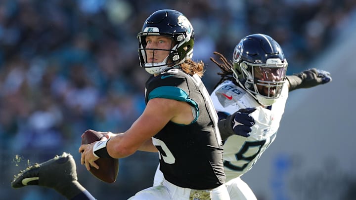 Nov 19, 2023; Jacksonville, Florida, USA;  Jacksonville Jaguars quarterback Trevor Lawrence (16) is pressured by Tennessee Titans defensive end Denico Autry (96) in the third quarter at EverBank Stadium. Mandatory Credit: Nathan Ray Seebeck-Imagn Images