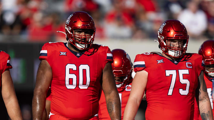Nov 30, 2024; Tucson, Arizona, USA; Arizona Wildcats offensive lineman Alexander Doost (60) and Josh Baker (75) against the Arizona State Sun Devils during the Territorial Cup at Arizona Stadium. Mandatory Credit: Mark J. Rebilas-Imagn Images Nov 30, 2024; Tucson, Arizona, USA; Arizona Wildcats offensive lineman Alexander Doost (60) and Josh Baker (75) against the Arizona State Sun Devils during the Territorial Cup at Arizona Stadium. Mandatory Credit: Mark J. Rebilas-Imagn Images