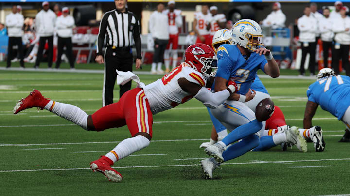 Jan 7, 2024; Inglewood, California, USA; Los Angeles Chargers quarterback Easton Stick (2) fumbles the ball as Kansas City Chiefs defensive end Charles Omenihu (90) tackled him during the first quarter at SoFi Stadium. Mandatory Credit: Kiyoshi Mio-Imagn Images Jan 7, 2024; Inglewood, California, USA; Los Angeles Chargers quarterback Easton Stick (2) fumbles the ball as Kansas City Chiefs defensive end Charles Omenihu (90) tackled him during the first quarter at SoFi Stadium. Mandatory Credit: Kiyoshi Mio-Imagn Images