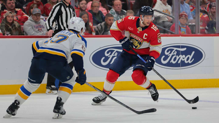 Dec 20, 2024; Sunrise, Florida, USA; Florida Panthers center Aleksander Barkov (16) moves the puck as St. Louis Blues defenseman Cam Fowler (17) defends during the second period at Amerant Bank Arena. Mandatory Credit: Sam Navarro-Imagn Images