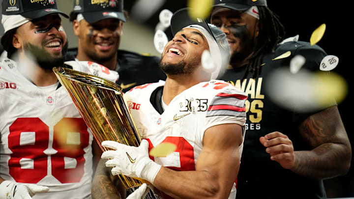 Ohio State Buckeyes running back TreVeyon Henderson (32) holds the trophy following the 34-23 win over the Notre Dame Fighting Irish to win the College Football Playoff National Championship at Mercedes-Benz Stadium in Atlanta on Jan. 21, 2025.