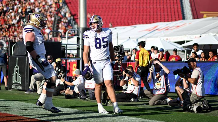 Tight end Baron Naone (85) is greeted by lineman John Mills after scoring a first-quarter touchdown. Tight end Baron Naone (85) is greeted by lineman John Mills after scoring a first-quarter touchdown.