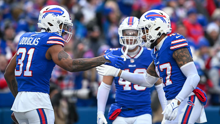 Dec 31, 2023; Orchard Park, New York, USA; Buffalo Bills cornerback Rasul Douglas (31) and cornerback Christian Benford (47) celebrate a turnover against the New England Patriots with linebacker Terrel Bernard (43) in the first quarter at Highmark Stadium. Mandatory Credit: Mark Konezny-USA TODAY Sports