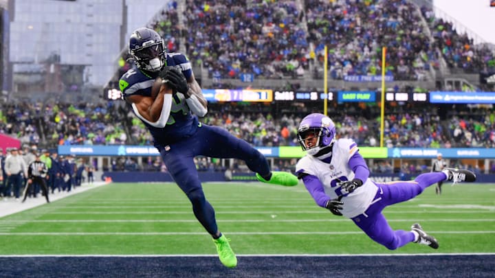 Dec 22, 2024; Seattle, Washington, USA; Seattle Seahawks wide receiver DK Metcalf (14) catches a pass for a touchdown while defended by Minnesota Vikings cornerback Stephon Gilmore (2) during the first half at Lumen Field. Mandatory Credit: Steven Bisig-Imagn Images Dec 22, 2024; Seattle, Washington, USA; Seattle Seahawks wide receiver DK Metcalf (14) catches a pass for a touchdown while defended by Minnesota Vikings cornerback Stephon Gilmore (2) during the first half at Lumen Field. Mandatory Credit: Steven Bisig-Imagn Images