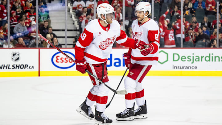 Feb 1, 2025; Calgary, Alberta, CAN; Detroit Red Wings center Andrew Copp (18) celebrates with defenseman Ben Chiarot (8) after scoring an empty net goal against the Calgary Flames during the third period at Scotiabank Saddledome. Mandatory Credit: Brett Holmes-Imagn Images