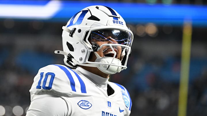 Dec 6, 2025; Charlotte, NC, USA; Duke Blue Devils quarterback Darian Mensah (10) celebrates after the Blue Devils score a touchdown in overtime during the  ACC Championship game at Bank of America Stadium. Mandatory Credit: Bob Donnan-Imagn Images