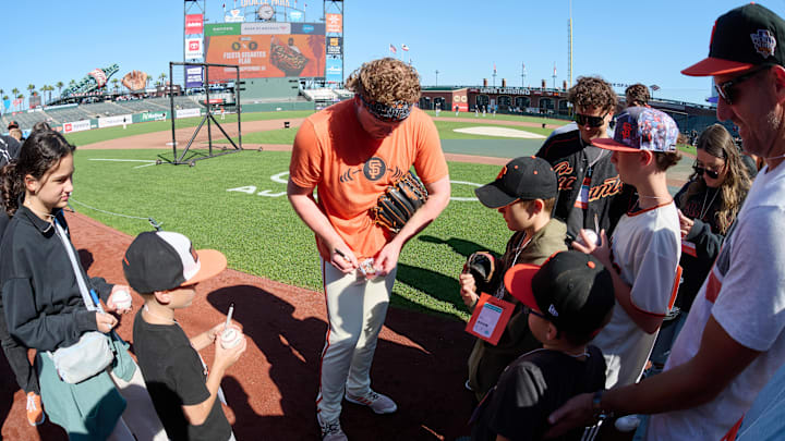 Aug 31, 2024; San Francisco, California, USA; San Francisco Giants pitcher Logan Webb (62) signs autographs for fans before the game between the San Francisco Giants and the Miami Marlins at Oracle Park.