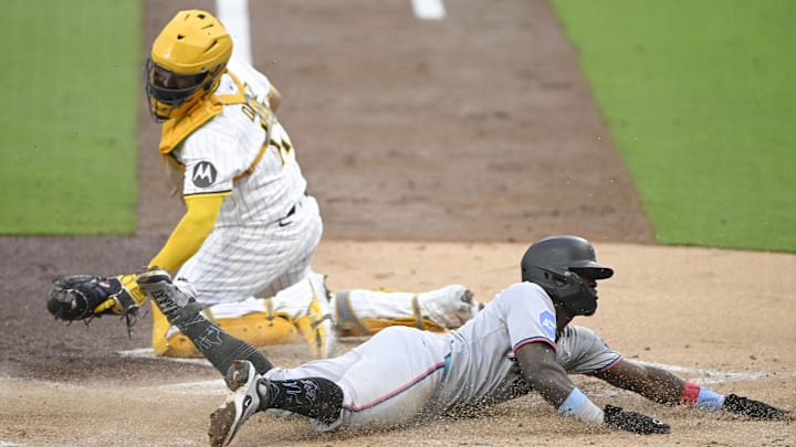 Miami Marlins outfielder Ronny Simon (41) scores ahead of the tag of San Diego Padres catcher Elias Díaz (17) during the first inning at Petco Park on May 27. Miami Marlins outfielder Ronny Simon (41) scores ahead of the tag of San Diego Padres catcher Elias Díaz (17) during the first inning at Petco Park on May 27.