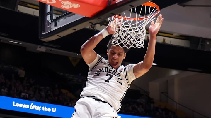 Feb 14, 2026; Nashville, Tennessee, USA;  Vanderbilt Commodores guard Chandler Bing (7) dunks the ball over Texas A&M Aggies guard Jacari Lane (5) during the second half at Memorial Gymnasium. Mandatory Credit: Steve Roberts-Imagn Images