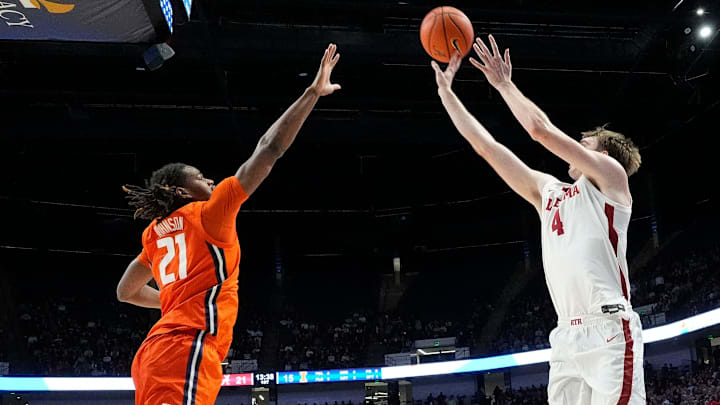 Nov 20, 2024; Birmingham, AL, USA; Illinois forward Morez Johnson Jr. (21) defends a three pointer by Alabama forward Grant Nelson (4) in the CM Newton Classic at Legacy Arena. Mandatory Credit: Gary Cosby Jr.-Tuscaloosa News