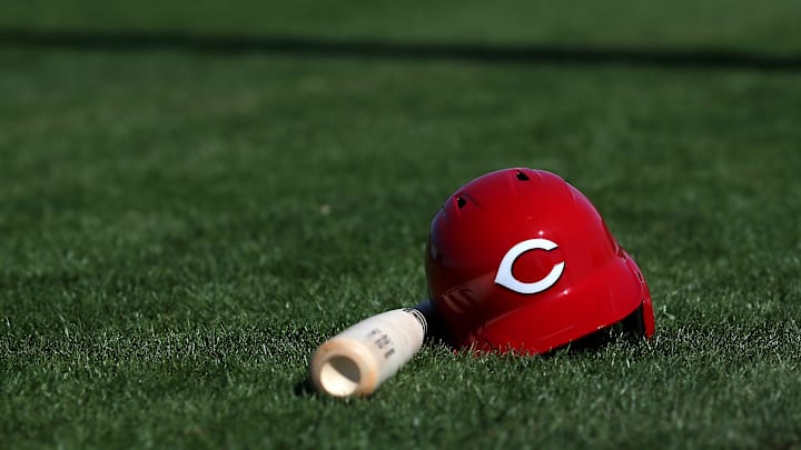 Cincinnati Reds third baseman Eugenio Suarez's (7) bat and helmet rest on the field, Thursday, Feb. 20, 2020, at the baseball team's spring training facility in Goodyear, Ariz. Cincinnati Reds third baseman Eugenio Suarez's (7) bat and helmet rest on the field, Thursday, Feb. 20, 2020, at the baseball team's spring training facility in Goodyear, Ariz.