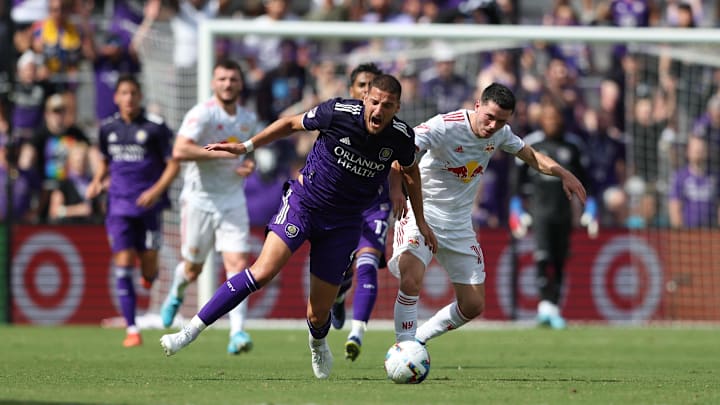 Apr 24, 2022; Orlando, Florida, USA; Orlando City forward Ercan Kara (9) battles New York Red Bulls