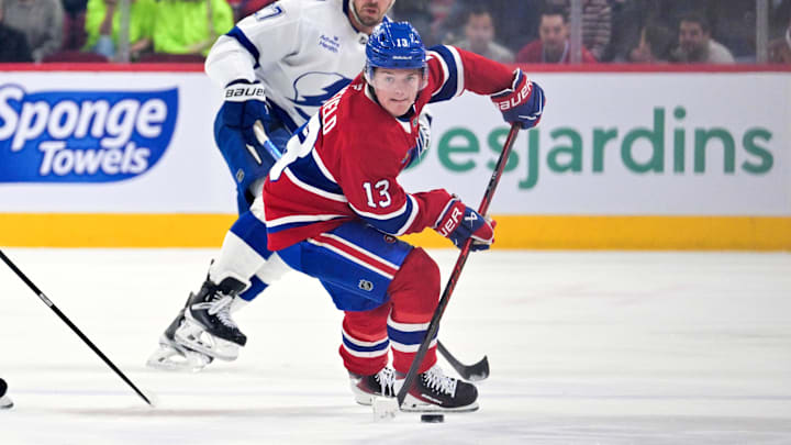 Apr 9, 2026; Montreal, Quebec, CAN; Montreal Canadiens forward Cole Caufield (13) plays the puck against Tampa Bay Lightning defenseman Ryan McDonagh (27) during the first period at the Bell Centre. Mandatory Credit: Eric Bolte-Imagn Images