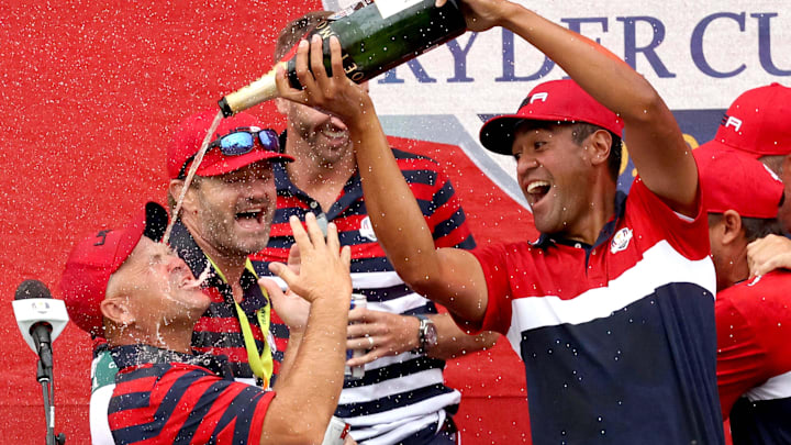 Team USA player Tony Finau pours champagne  into a caddies mouth during the trophy presentation after winning the 43rd Ryder Cup at Whistling Straits, in Haven, Wis. on Sunday, Sept. 26, 2021.