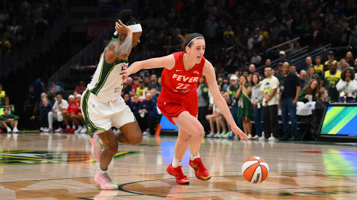 Jun 24, 2025; Seattle, Washington, USA; Indiana Fever guard Caitlin Clark (22) advances the ball while guarded by Seattle Storm guard Erica Wheeler (17) during the second half at Climate Pledge Arena. Mandatory Credit: Steven Bisig-Imagn Images Jun 24, 2025; Seattle, Washington, USA; Indiana Fever guard Caitlin Clark (22) advances the ball while guarded by Seattle Storm guard Erica Wheeler (17) during the second half at Climate Pledge Arena. Mandatory Credit: Steven Bisig-Imagn Images