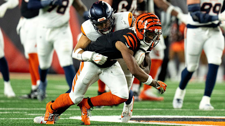 Denver Broncos inside linebacker Justin Strnad (40) tackles Cincinnati Bengals wide receiver Ja'Marr Chase (1) in the third quarter of the NFL game at Paycor Stadium in Cincinnati on Saturday, Dec. 28, 2024.