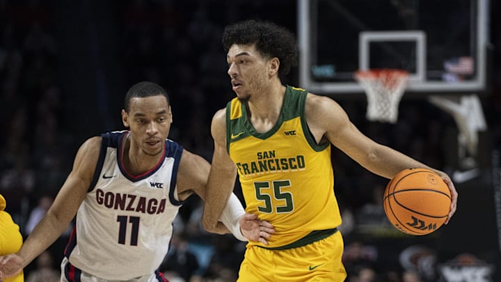 March 11, 2024; Las Vegas, NV, USA; San Francisco Dons guard Marcus Williams (55) dribbles the basketball against Gonzaga Bulldogs guard Nolan Hickman (11) during the first half in the semifinals of the WCC Basketball Championship at Orleans Arena. 