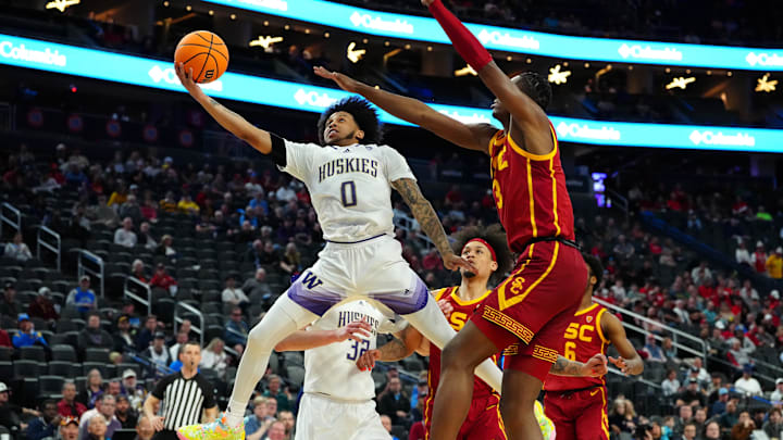 Huskies guard Koren Johnson (0) drives against USC in 2024.