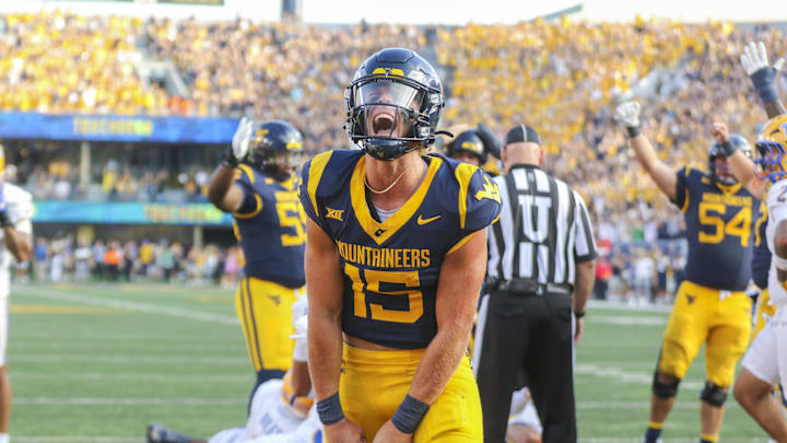 Sep 13, 2025; Morgantown, West Virginia, USA; West Virginia Mountaineers quarterback Scotty Fox Jr. (15) celebrates after a touchdown during the third quarter against the Pittsburgh Panthers at Milan Puskar Stadium. Mandatory Credit: Ben Queen-Imagn Images