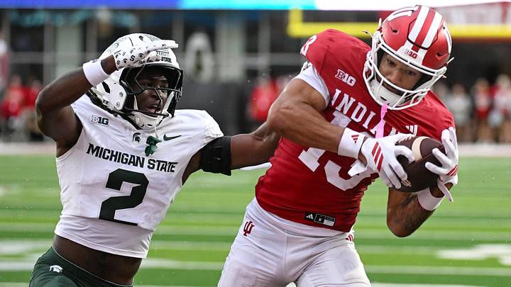 Oct 18, 2025; Bloomington, Indiana, USA; Indiana Hoosiers wide receiver Elijah Sarratt (13) catches a pass for a touchdown against Michigan State Spartans defensive back Aydan West (2) during the second half at Memorial Stadium. Mandatory Credit: Robert Goddin-Imagn Images Oct 18, 2025; Bloomington, Indiana, USA; Indiana Hoosiers wide receiver Elijah Sarratt (13) catches a pass for a touchdown against Michigan State Spartans defensive back Aydan West (2) during the second half at Memorial Stadium. Mandatory Credit: Robert Goddin-Imagn Images