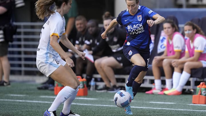 Aug 7, 2022; Seattle, Washington, OL Reign forward Megan Rapinoe (15) handles the ball as Houston's Katie Naughton defends.