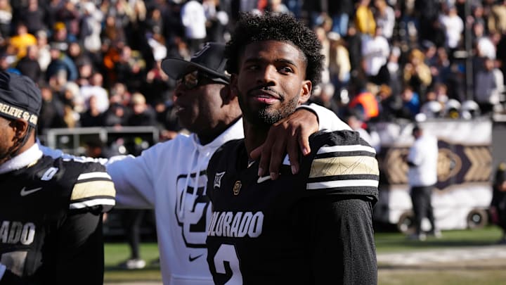 Colorado Buffaloes quarterback Shedeur Sanders and head coach Deion Sanders on the field for Senior Day. 