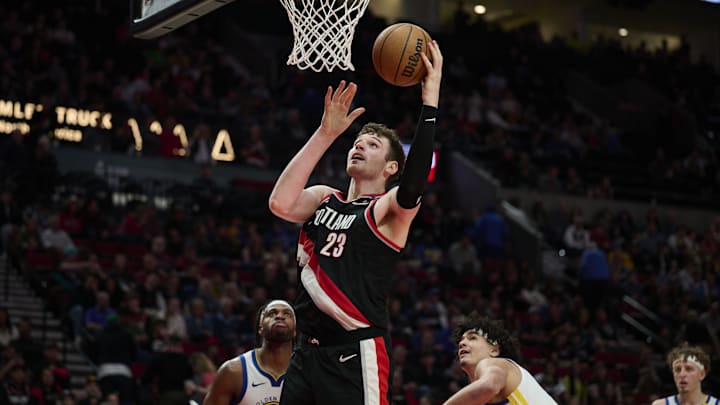 Apr 11, 2025; Portland, Oregon, USA; Portland Trail Blazers center Donovan Clingan (23) scores a basket during the second half against the Golden State Warriors at Moda Center. Mandatory Credit: Troy Wayrynen-Imagn Images