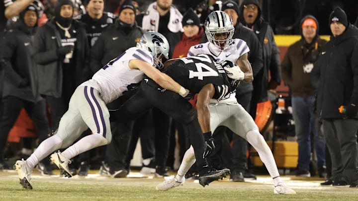 Nov 30, 2024; Ames, Iowa, USA; Iowa State Cyclones running back Abu Sama III (24) is tackled by Kansas State Wildcats linebacker Austin Moore (41) and Kansas State Wildcats safety VJ Payne (19) in the second quarter at Jack Trice Stadium. Mandatory Credit: Reese Strickland-Imagn Images Nov 30, 2024; Ames, Iowa, USA; Iowa State Cyclones running back Abu Sama III (24) is tackled by Kansas State Wildcats linebacker Austin Moore (41) and Kansas State Wildcats safety VJ Payne (19) in the second quarter at Jack Trice Stadium. Mandatory Credit: Reese Strickland-Imagn Images