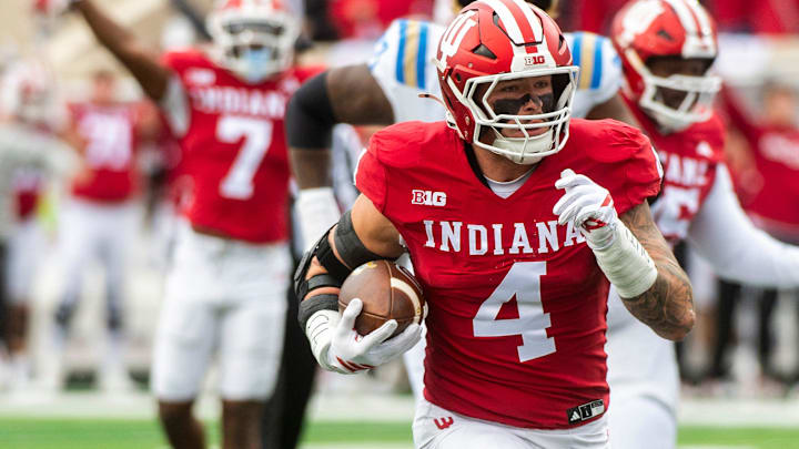 Indiana's Aiden Fisher (4) returns an interception for a touchdown vs UCLA on Oct. 25, 2025, at Memorial Stadium. Indiana's Aiden Fisher (4) returns an interception for a touchdown vs UCLA on Oct. 25, 2025, at Memorial Stadium.
