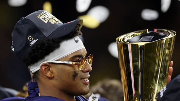 Jan 8, 2024; Houston, TX, USA; Michigan Wolverines defensive back Will Johnson (2) holds the National Championship Trophy after winning 2024 College Football Playoff national championship game against the Washington Huskies at NRG Stadium. Mandatory Credit: Thomas Shea-Imagn Images