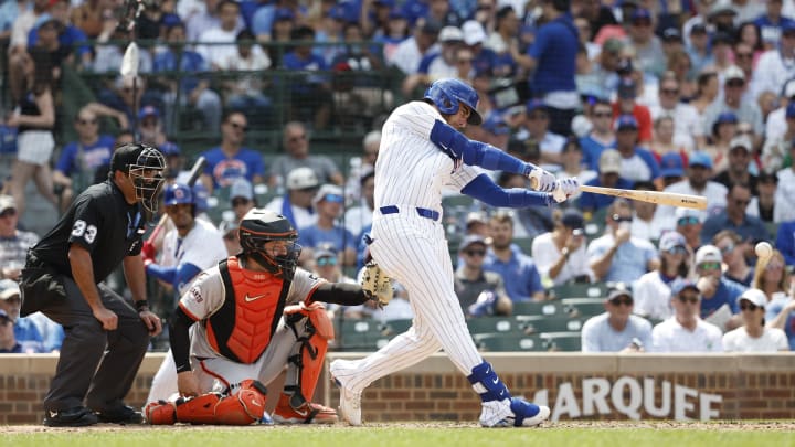 Jun 19, 2024; Chicago, Illinois, USA; Chicago Cubs outfielder Cody Bellinger (24) singles against the San Francisco Giants during the seventh inning at Wrigley Field. Mandatory Credit: Kamil Krzaczynski-USA TODAY Sports
