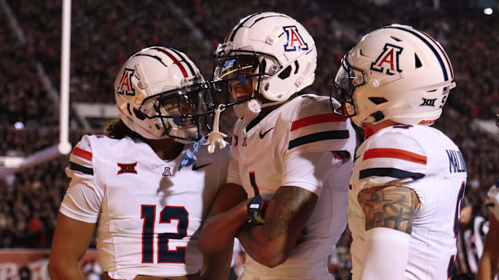 Sep 28, 2024; Salt Lake City, Utah, USA; Arizona Wildcats defensive back Genesis Smith (12) along with defensive back Tacario Davis (1) and defensive back Gunner Maldonado (9) react to a play against the Utah Utes during the second quarter at Rice-Eccles Stadium. 