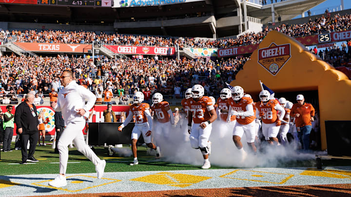 Dec 31, 2025; Orlando, FL, USA; Texas Longhorns head coach Steve Sarkisian, Texas Longhorns wide receiver Parker Livingstone (13) and offensive lineman Brandon Baker (73) run onto the field before a game against the Michigan Wolverines at Camping World Stadium. Mandatory Credit: Matt Pendleton-Imagn Images Dec 31, 2025; Orlando, FL, USA; Texas Longhorns head coach Steve Sarkisian, Texas Longhorns wide receiver Parker Livingstone (13) and offensive lineman Brandon Baker (73) run onto the field before a game against the Michigan Wolverines at Camping World Stadium. Mandatory Credit: Matt Pendleton-Imagn Images