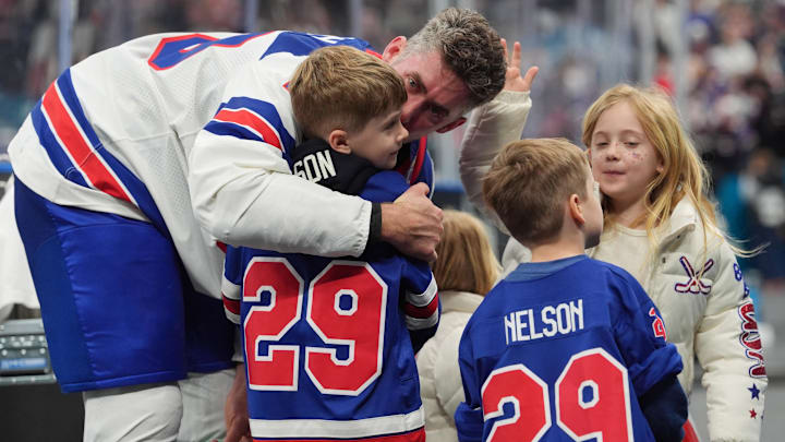 Feb 22, 2026; Milan, Italy; Brock Nelson (29) of the United States celebrates with his family after defeating Canada in the men's ice hockey gold medal game during the Milano Cortina 2026 Olympic Winter Games at Milano Santagiulia Ice Hockey Arena. Mandatory Credit: Amber Searls-Imagn Images