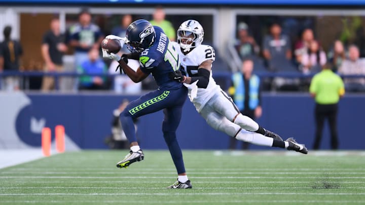 Aug 7, 2025; Seattle, Washington, USA; Seattle Seahawks wide receiver Tory Horton (15) catches a pass while covered by Las Vegas Raiders cornerback Decamerion Richardson (25) during the first half at Lumen Field.