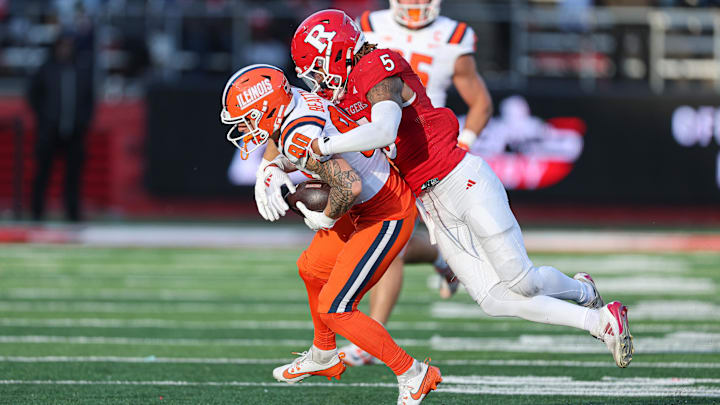 Nov 23, 2024; Piscataway, New Jersey, USA; Illinois Fighting Illini wide receiver Hank Beatty (80) is tackled by Rutgers Scarlet Knights defensive back Kaj Sanders (5) during the second half at SHI Stadium. Mandatory Credit: Vincent Carchietta-Imagn Images