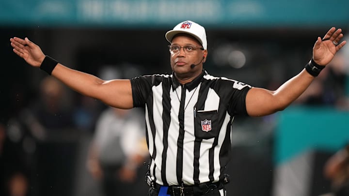 NFL referee Ron Tolbert signals during the second half between the Miami Dolphins and the Baltimore Ravens.